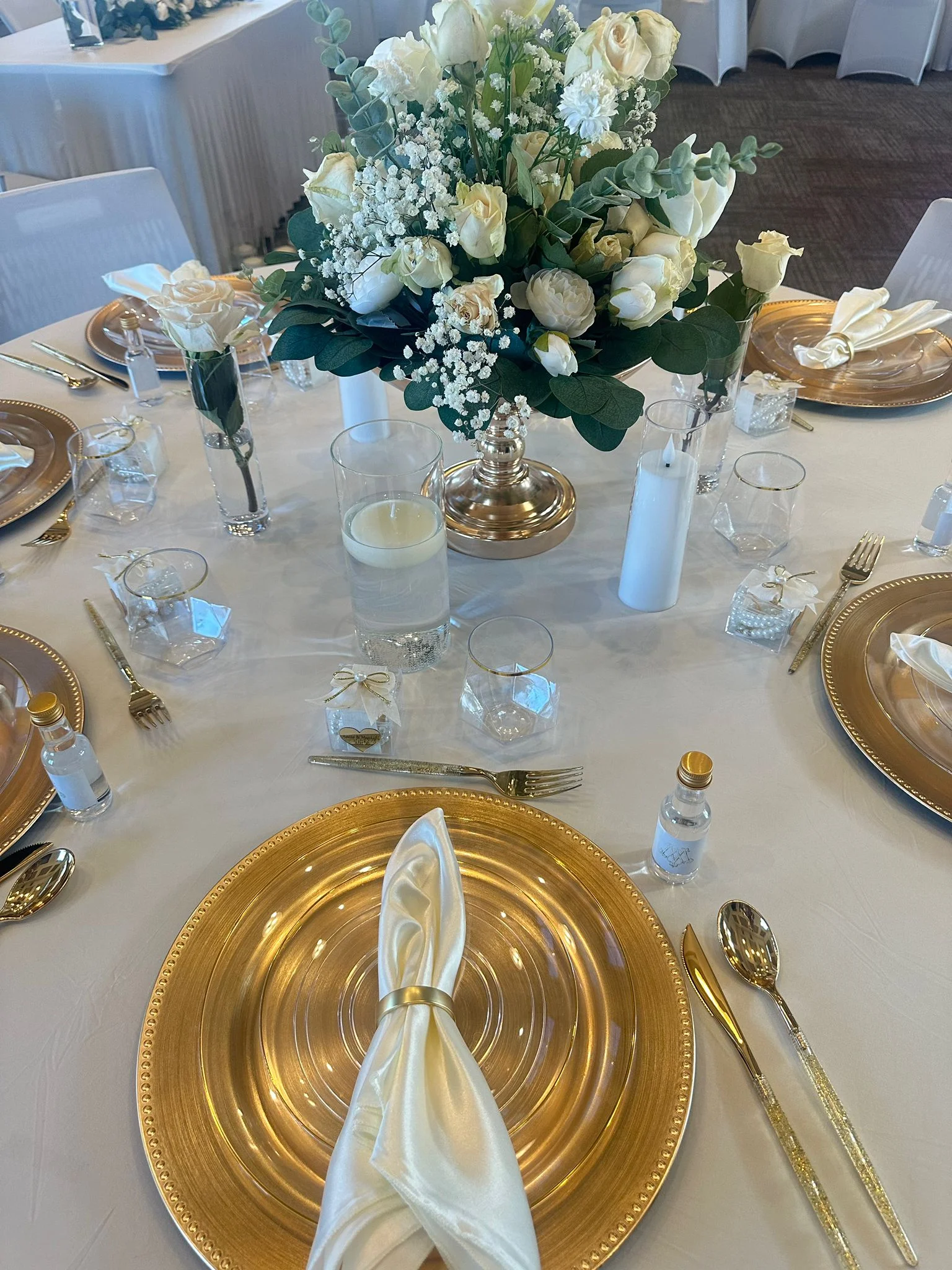 A refined tablescape with eucalyptus, roses and candles
